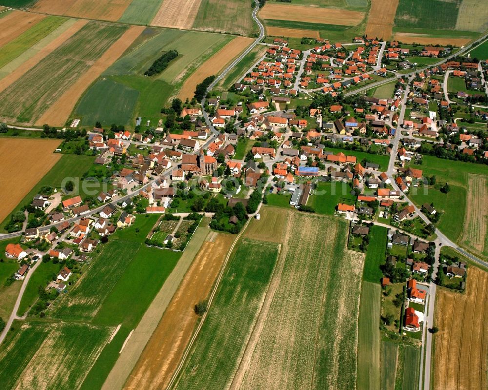 Königshofen a.d.Heide from the bird's eye view: Agricultural land and field boundaries surround the settlement area of the village in Königshofen a.d.Heide in the state Bavaria, Germany