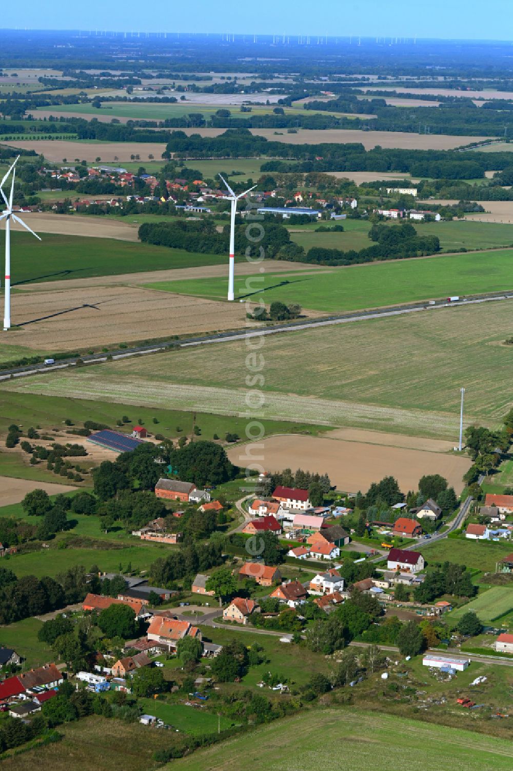 Könkendorf from above - Agricultural land and field boundaries surround the settlement area of the village in Koenkendorf in the state Brandenburg, Germany