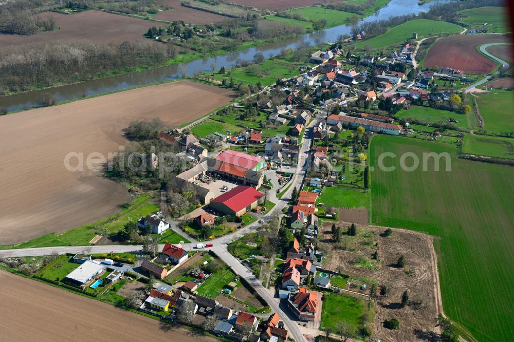 Aerial image Könnern - Agricultural land and field boundaries surround the settlement area of the village in Könnern in the state Saxony-Anhalt, Germany