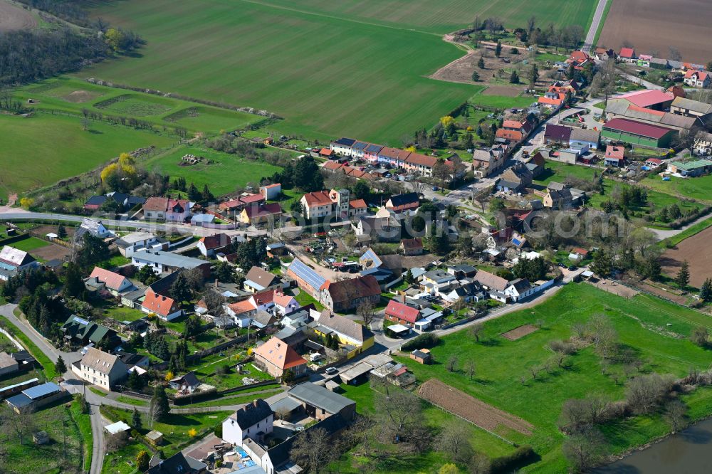 Könnern from above - Agricultural land and field boundaries surround the settlement area of the village in Könnern in the state Saxony-Anhalt, Germany