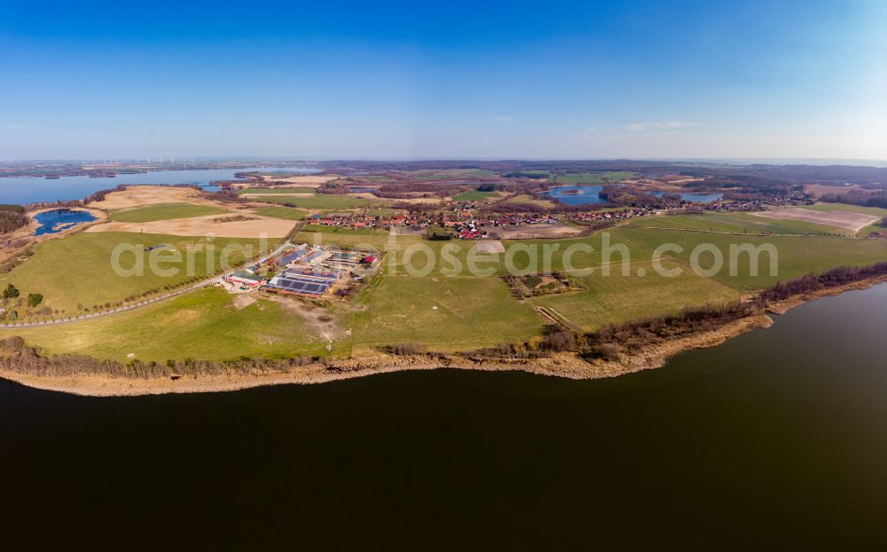 Chorin from above - Agricultural land and field boundaries surround the settlement area of the village vom Oekodorf Brodowin in Chorin in the state Brandenburg, Germany