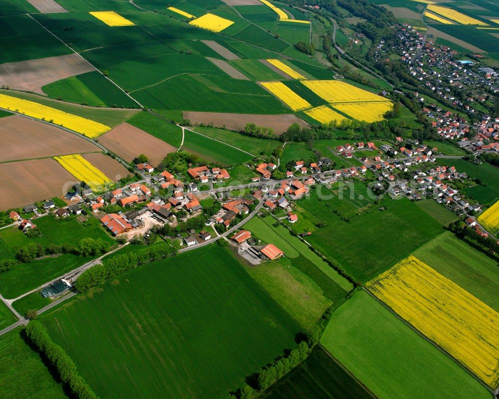 Konrode from the bird's eye view: Agricultural land and field boundaries surround the settlement area of the village in Konrode in the state Hesse, Germany