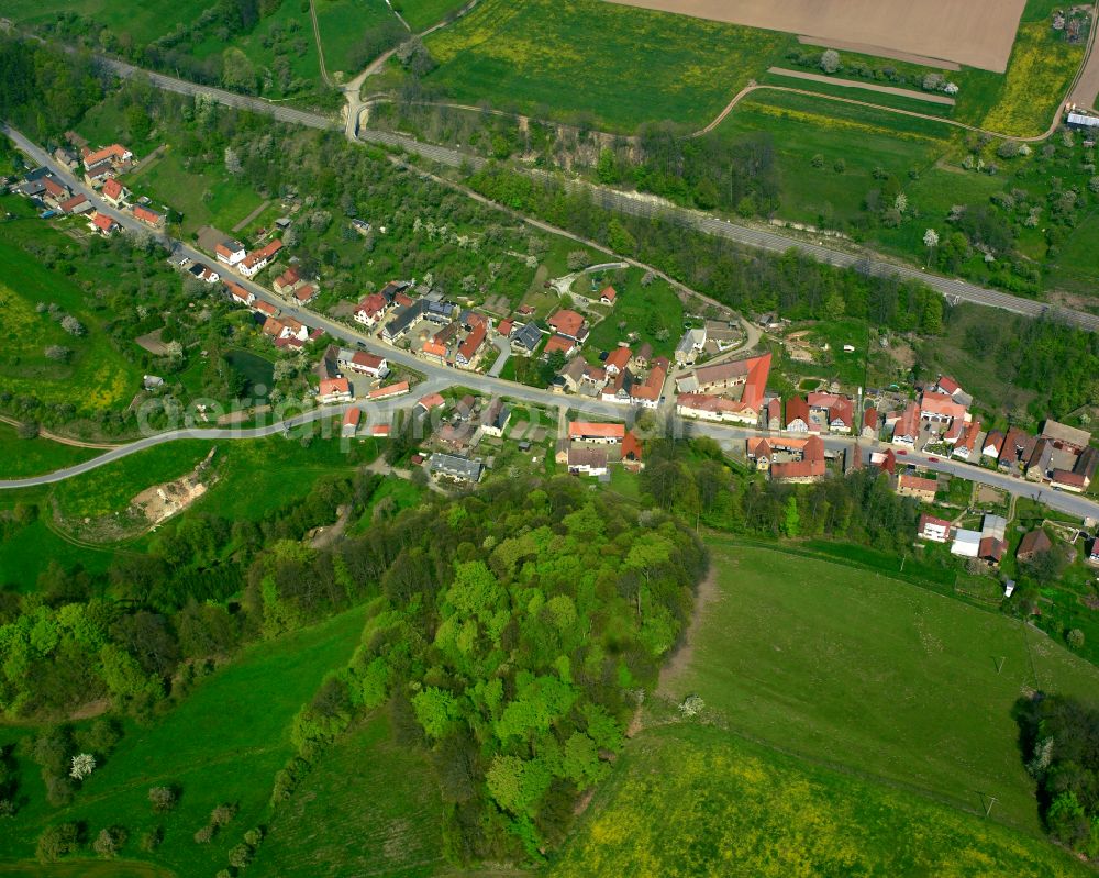 Kraftsdorf from above - Agricultural land and field boundaries surround the settlement area of the village in Kraftsdorf in the state Thuringia, Germany