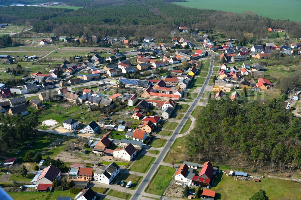 Krahne from above - Agricultural land and field boundaries surround the settlement area of the village in Krahne in the state Brandenburg, Germany