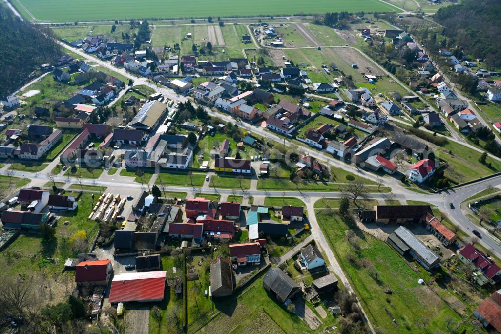 Krahne from the bird's eye view: Agricultural land and field boundaries surround the settlement area of the village in Krahne in the state Brandenburg, Germany