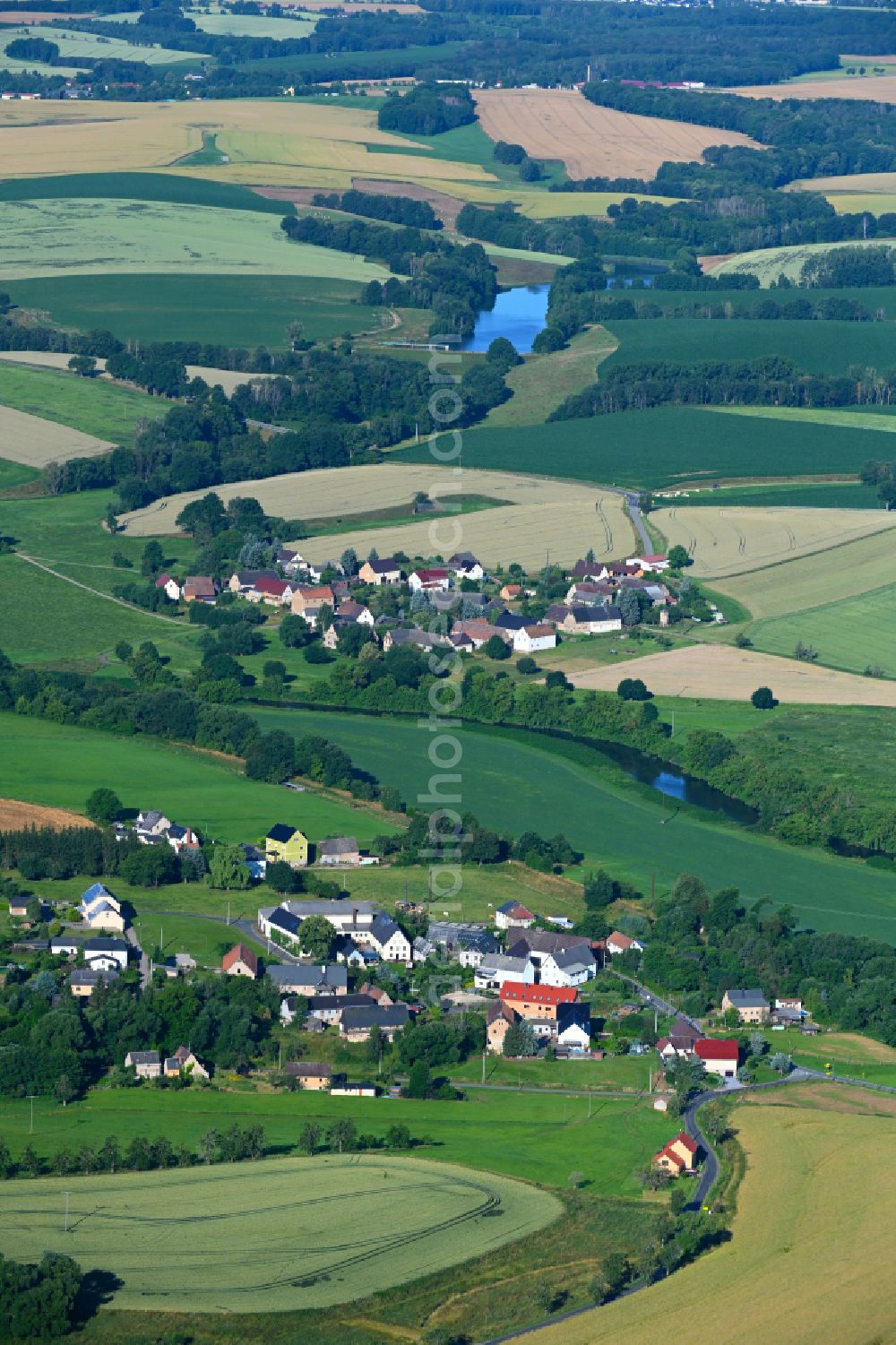 Kralapp from the bird's eye view: Agricultural land and field boundaries surround the settlement area of the village in Kralapp in the state Saxony, Germany