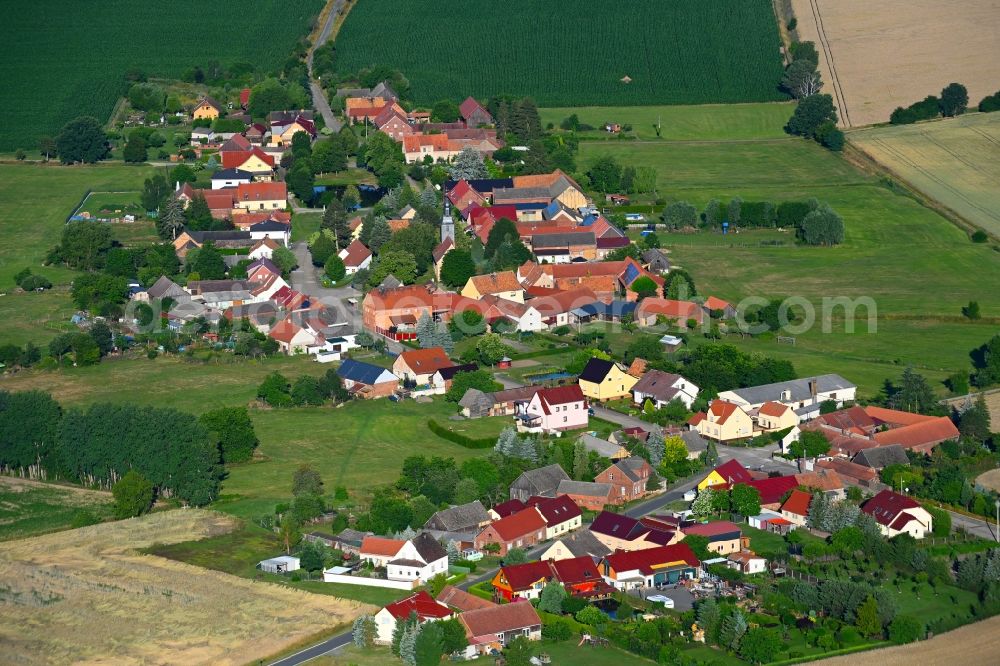 Aerial photograph Körba - Agricultural land and field boundaries surround the settlement area of the village in Koerba in the state Brandenburg, Germany