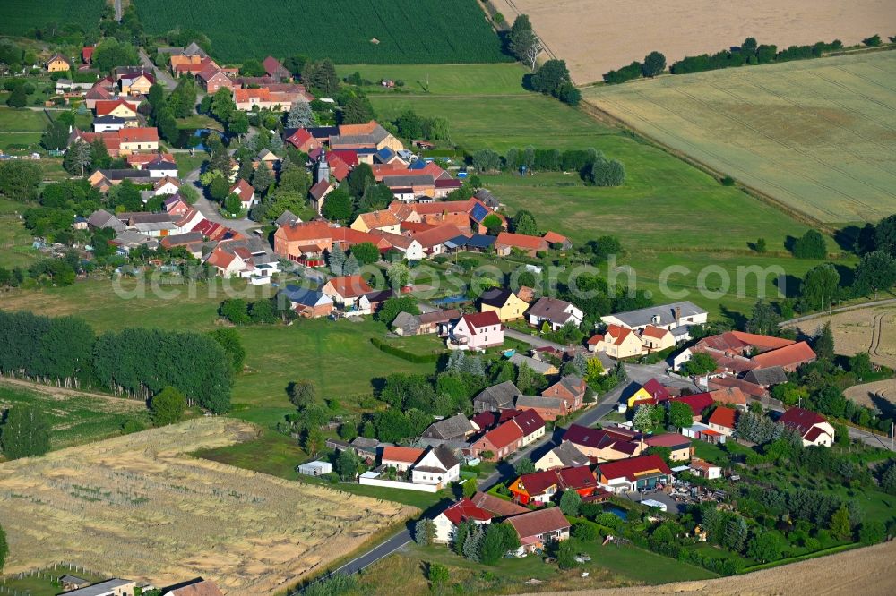 Körba from the bird's eye view: Agricultural land and field boundaries surround the settlement area of the village in Koerba in the state Brandenburg, Germany