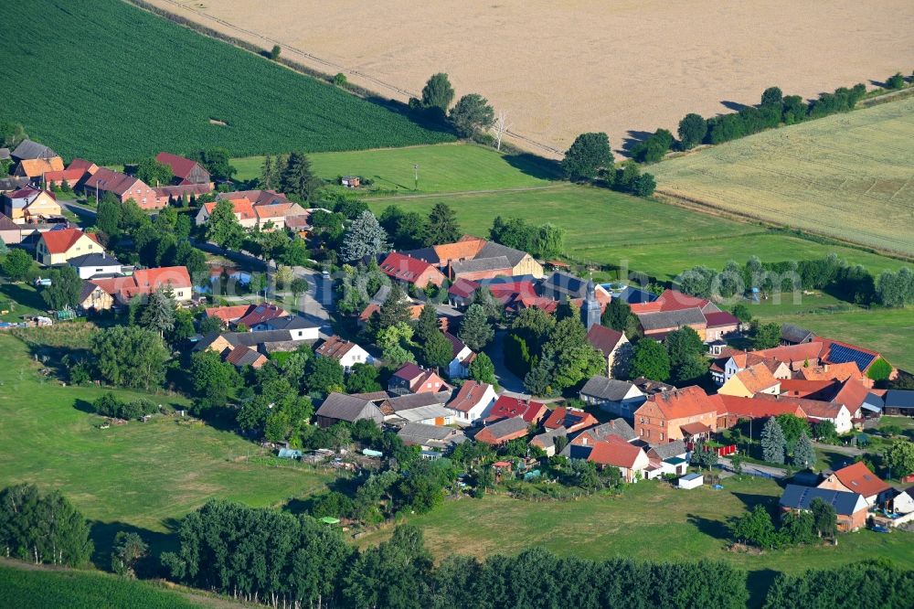 Aerial image Körba - Agricultural land and field boundaries surround the settlement area of the village in Koerba in the state Brandenburg, Germany