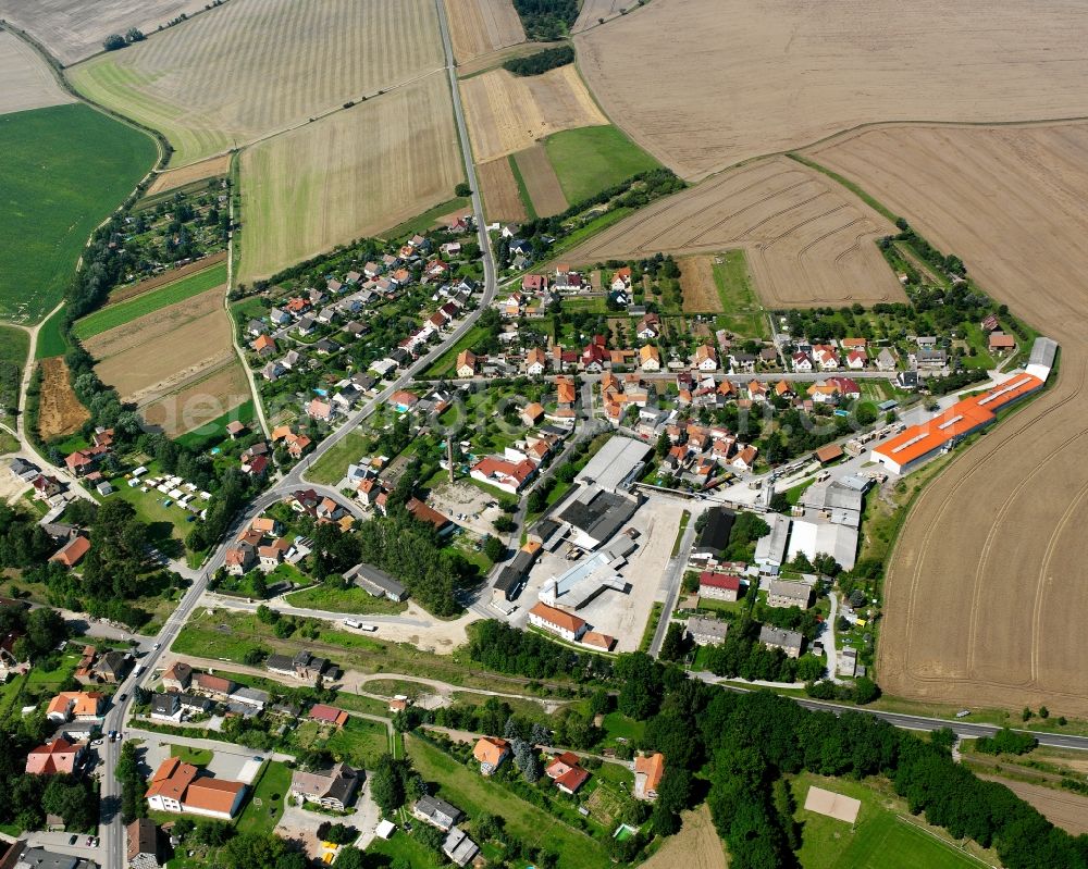 Körner from above - Agricultural land and field boundaries surround the settlement area of the village in Körner in the state Thuringia, Germany