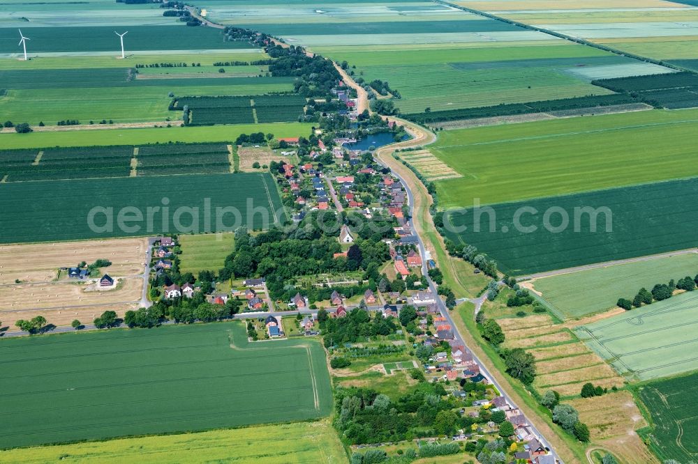 Krummendeich from above - Agricultural land and field boundaries surround the settlement area of the village in Krummendeich in the state Lower Saxony, Germany