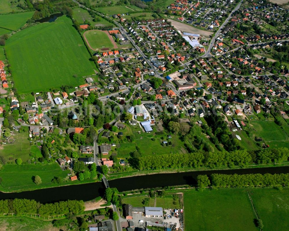 Krummesse from the bird's eye view: Agricultural land and field boundaries surround the settlement area of the village in Krummesse in the state Schleswig-Holstein, Germany