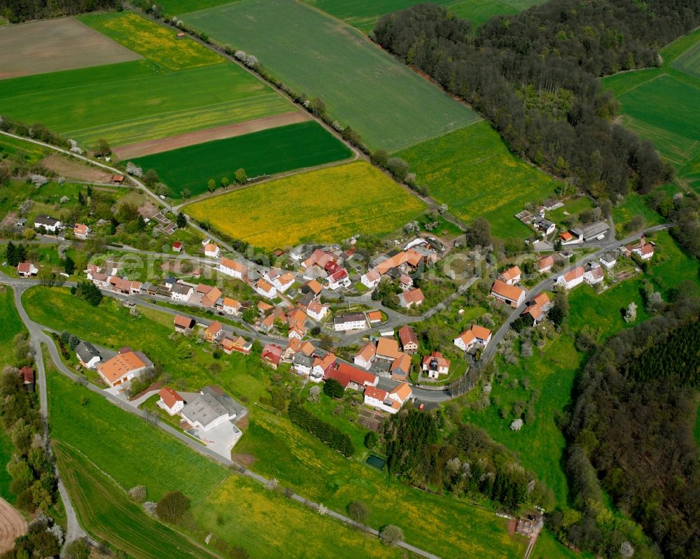 Kruspis from above - Agricultural land and field boundaries surround the settlement area of the village in Kruspis in the state Hesse, Germany