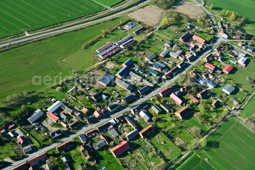 Kuhbier from the bird's eye view: Agricultural land and field boundaries surround the settlement area of the village in Kuhbier in the state Brandenburg, Germany