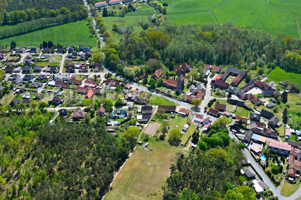 Kuhfelde from above - Agricultural land and field boundaries surround the settlement area of the village in Kuhfelde in the state Saxony-Anhalt, Germany