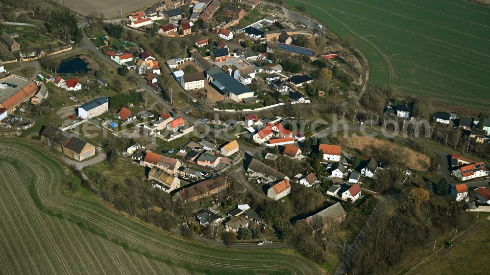 Kyhna from above - Agricultural land and field boundaries surround the settlement area of the village in Kyhna in the state Saxony, Germany