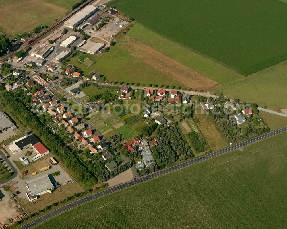 Lampertswalde from the bird's eye view: Agricultural land and field boundaries surround the settlement area of the village in Lampertswalde in the state Saxony, Germany