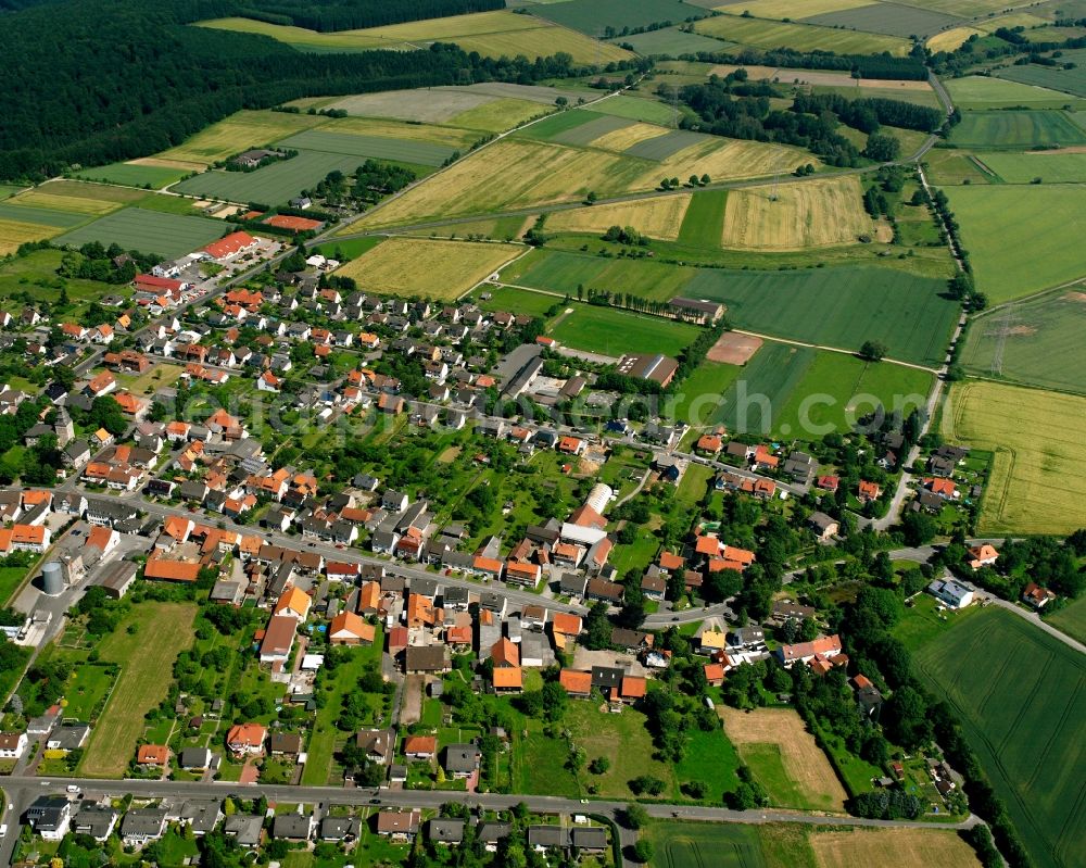 Landwehrhagen from the bird's eye view: Agricultural land and field boundaries surround the settlement area of the village in Landwehrhagen in the state Lower Saxony, Germany