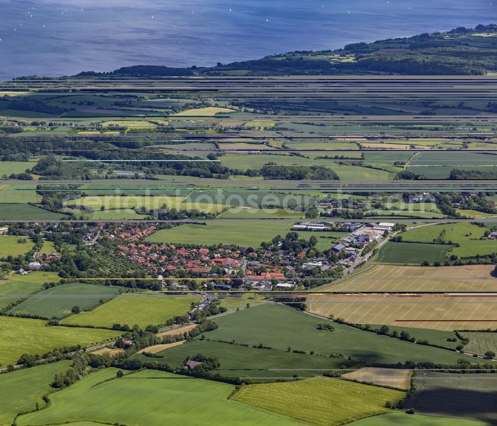 Aerial image Langballig - Agricultural land and field boundaries surround the settlement area of the village in Langballig in the state Schleswig-Holstein, Germany