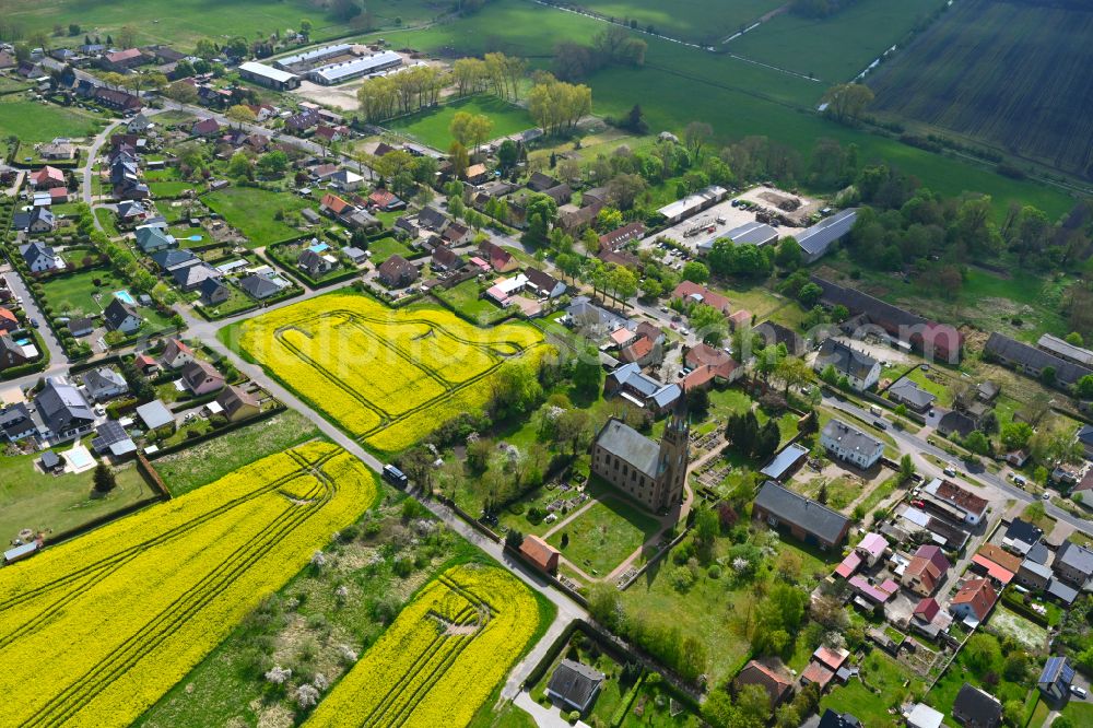 Langen from the bird's eye view: Agricultural land and field boundaries surround the settlement area of the village in Langen in the state Brandenburg, Germany