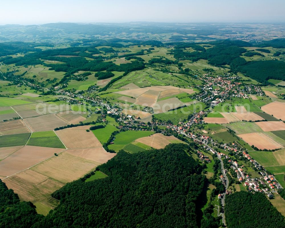 Langen-Brombach from the bird's eye view: Agricultural land and field boundaries surround the settlement area of the village in Langen-Brombach in the state Hesse, Germany