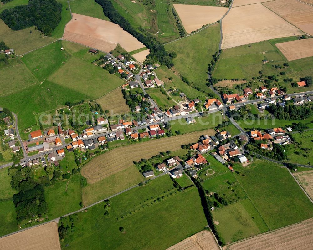 Langen-Brombach from above - Agricultural land and field boundaries surround the settlement area of the village in Langen-Brombach in the state Hesse, Germany