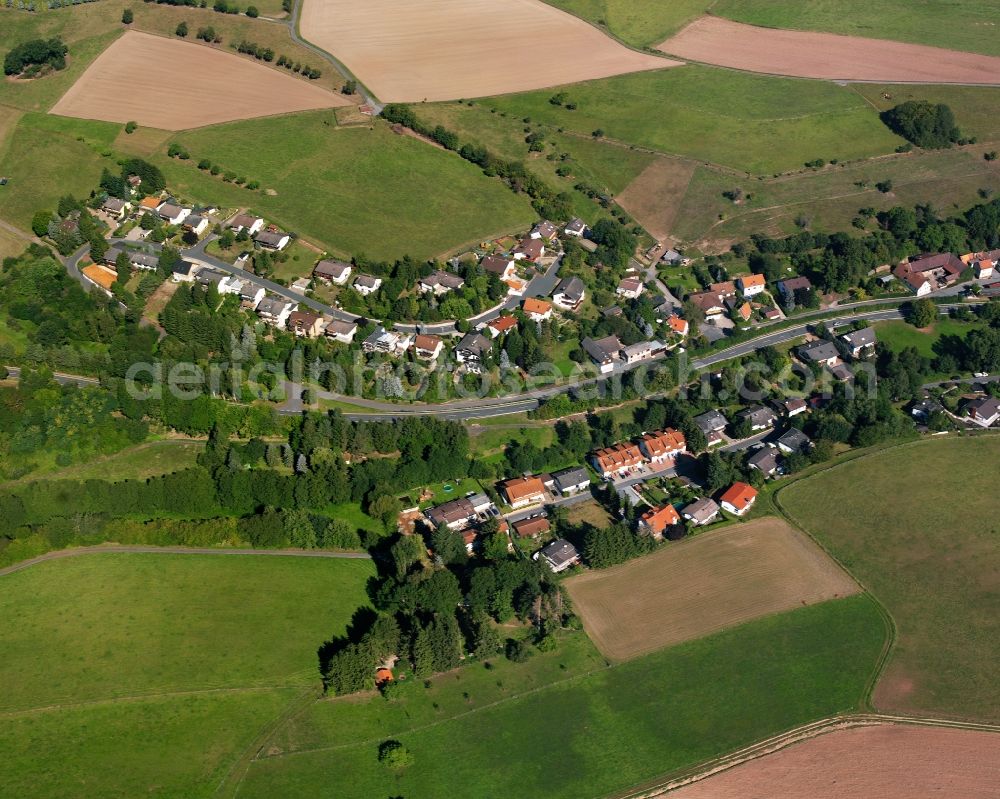 Langen-Brombach from above - Agricultural land and field boundaries surround the settlement area of the village in Langen-Brombach in the state Hesse, Germany