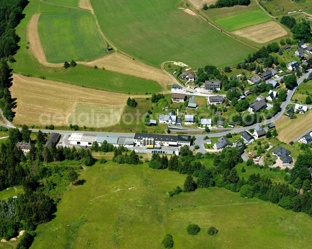 Langenbach from above - Agricultural land and field boundaries surround the settlement area of the village in Langenbach in the state Bavaria, Germany