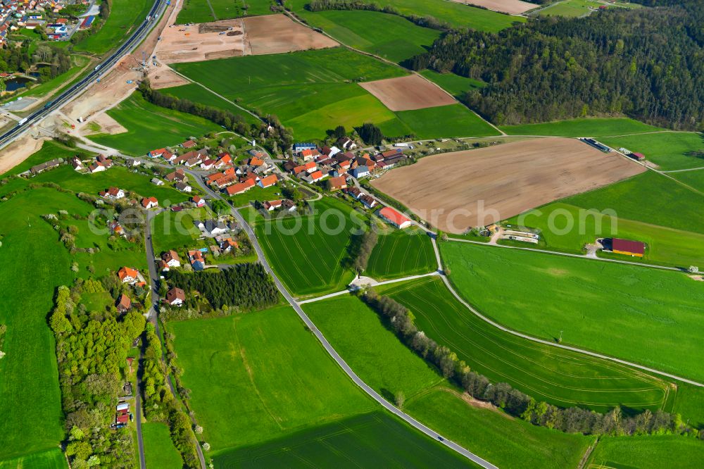 Aerial image Langenberg - Agricultural land and field boundaries surround the settlement area of the village in Langenberg in the state Bavaria, Germany