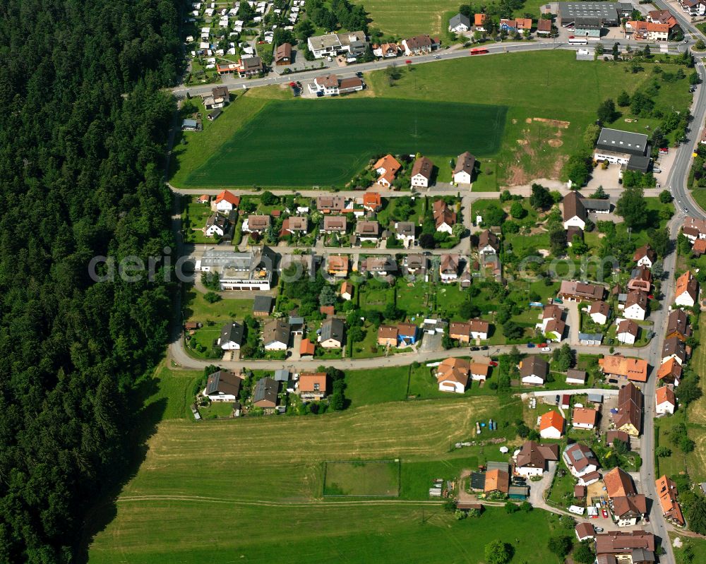 Langenbrand from the bird's eye view: Agricultural land and field boundaries surround the settlement area of the village in Langenbrand in the state Baden-Wuerttemberg, Germany