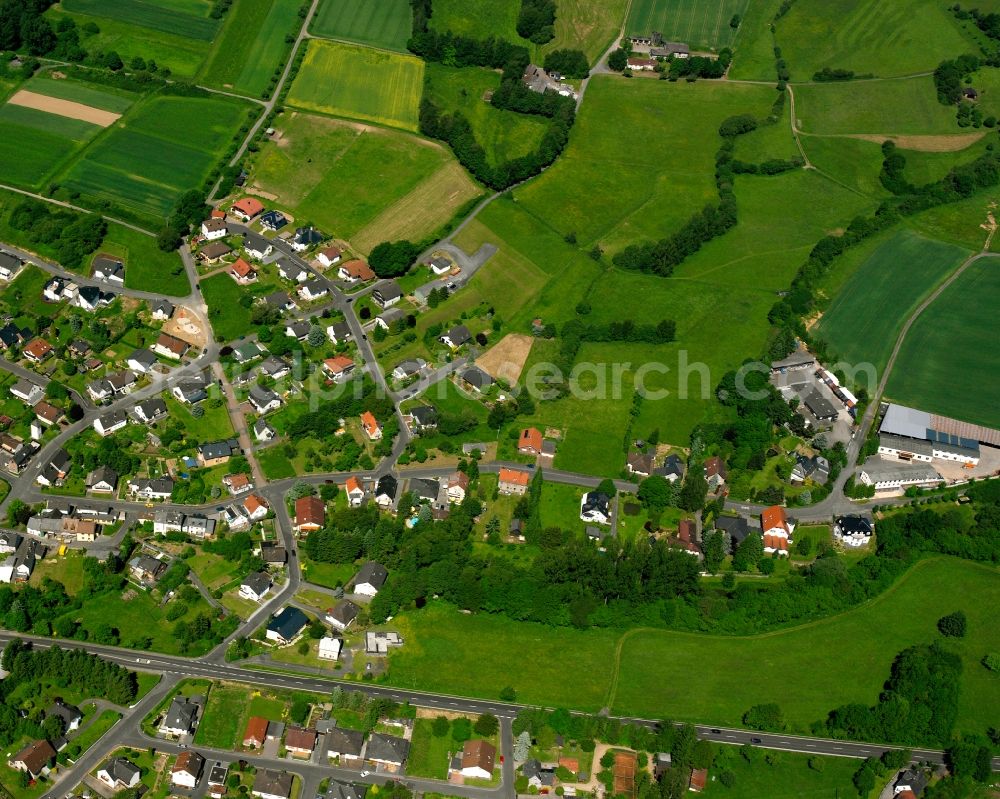Aerial photograph Langendernbach - Agricultural land and field boundaries surround the settlement area of the village in Langendernbach in the state Hesse, Germany