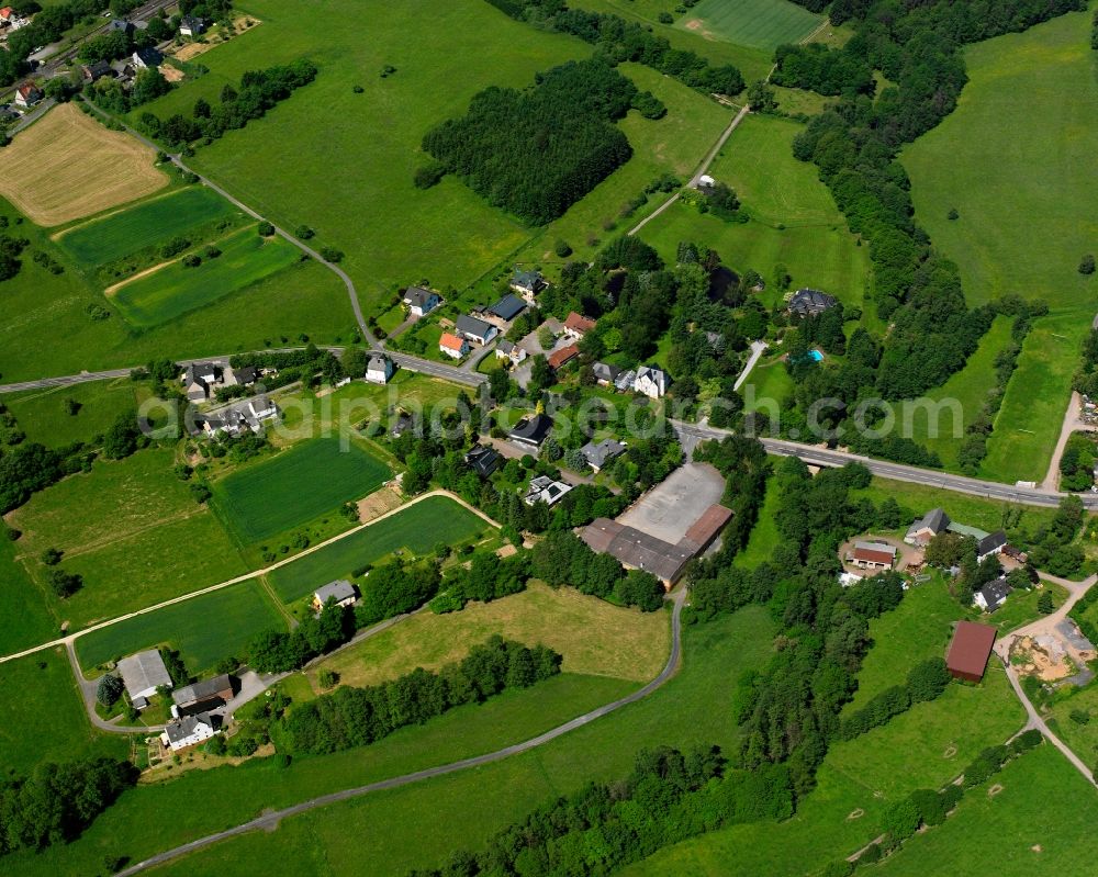 Langendernbach from the bird's eye view: Agricultural land and field boundaries surround the settlement area of the village in Langendernbach in the state Hesse, Germany