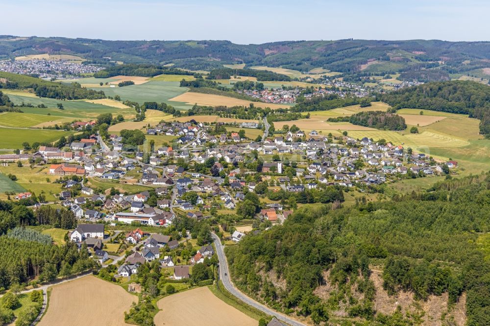 Langenholthausen from the bird's eye view: Agricultural land and field boundaries surround the settlement area of the village in Langenholthausen in the state North Rhine-Westphalia, Germany