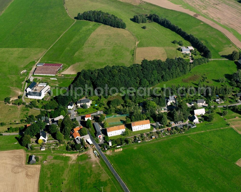 Langenstriegis from the bird's eye view: Agricultural land and field boundaries surround the settlement area of the village in Langenstriegis in the state Saxony, Germany