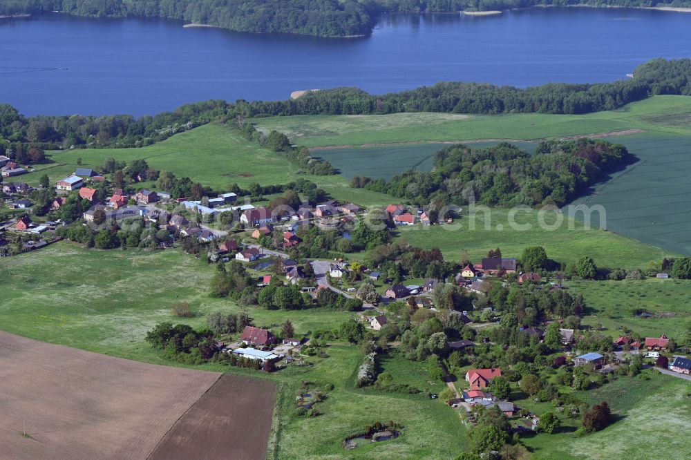 Lassahn from above - Agricultural land and field boundaries surround the settlement area of the village in Lassahn in the state Mecklenburg - Western Pomerania, Germany