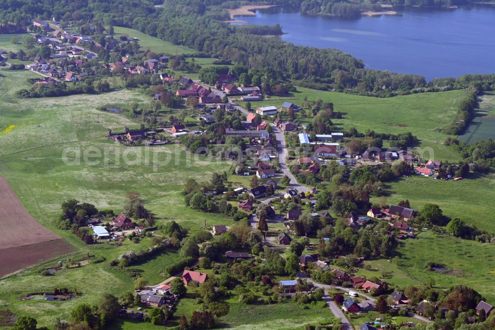 Lassahn from the bird's eye view: Agricultural land and field boundaries surround the settlement area of the village in Lassahn in the state Mecklenburg - Western Pomerania, Germany