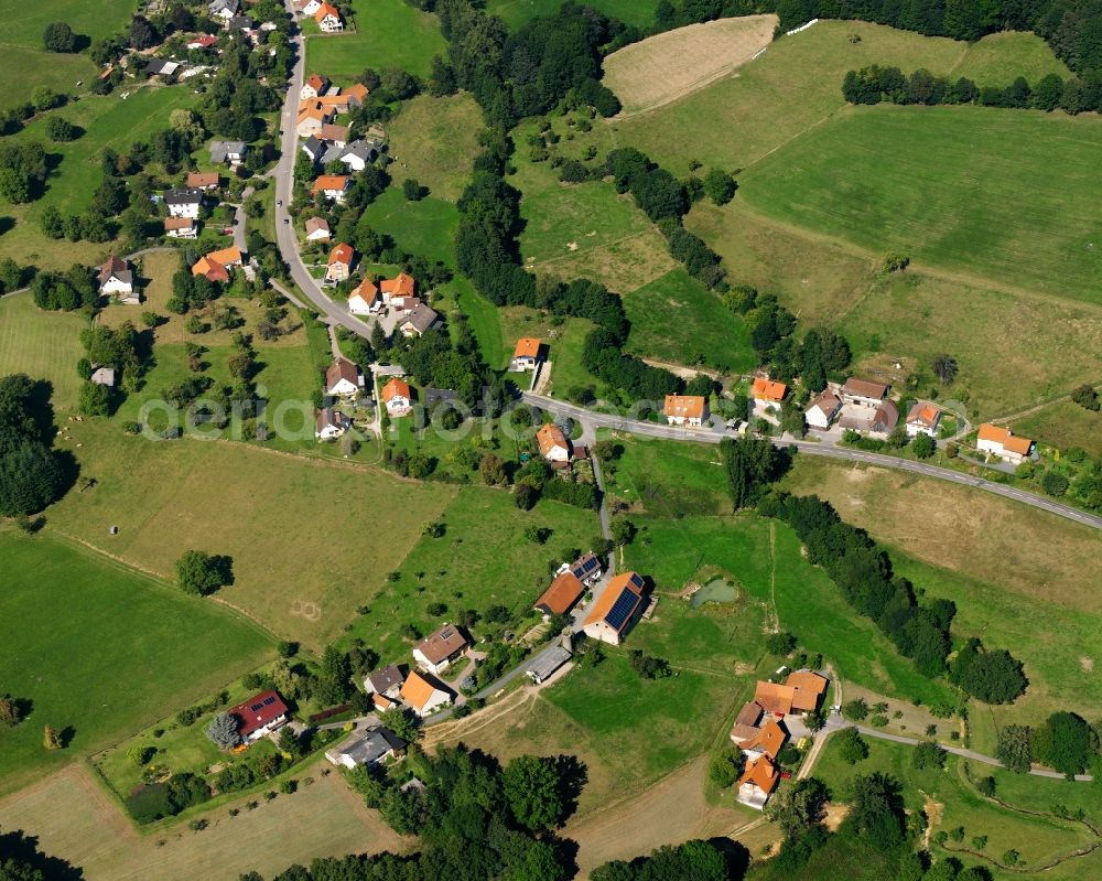 Aerial image Laudenau - Agricultural land and field boundaries surround the settlement area of the village in Laudenau in the state Hesse, Germany