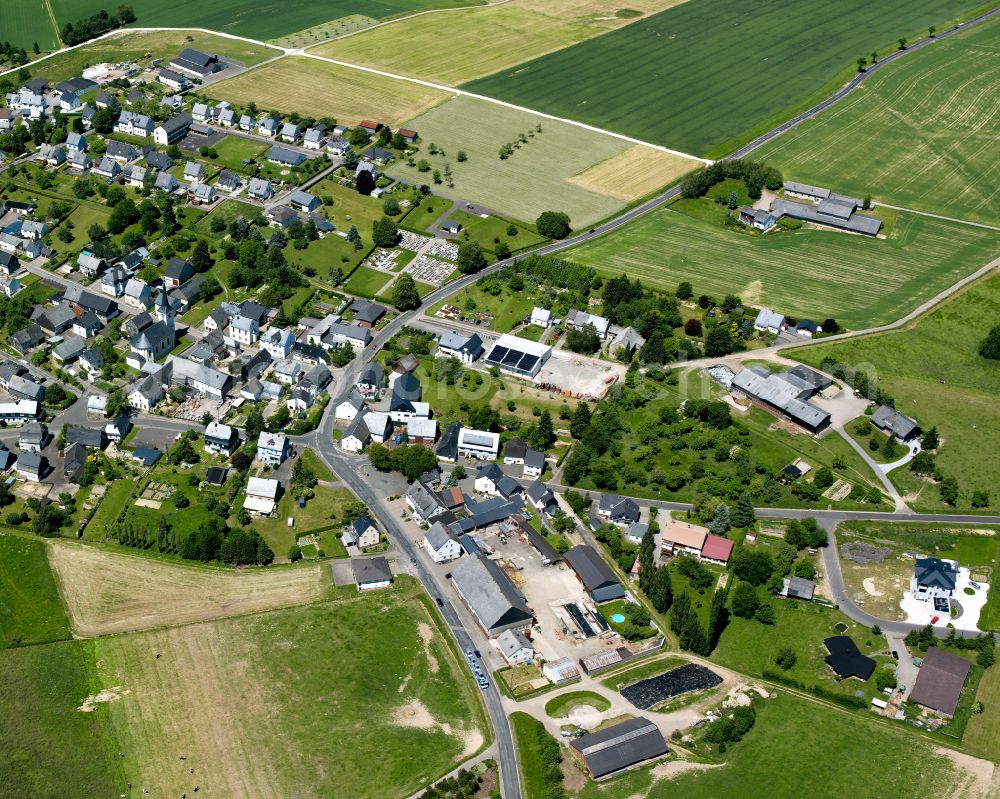 Laufersweiler from above - Agricultural land and field boundaries surround the settlement area of the village in Laufersweiler in the state Rhineland-Palatinate, Germany