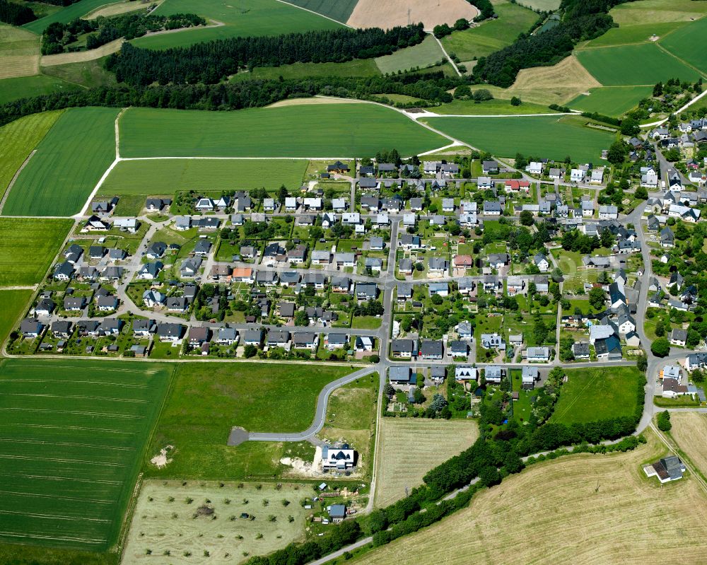 Aerial image Laufersweiler - Agricultural land and field boundaries surround the settlement area of the village in Laufersweiler in the state Rhineland-Palatinate, Germany