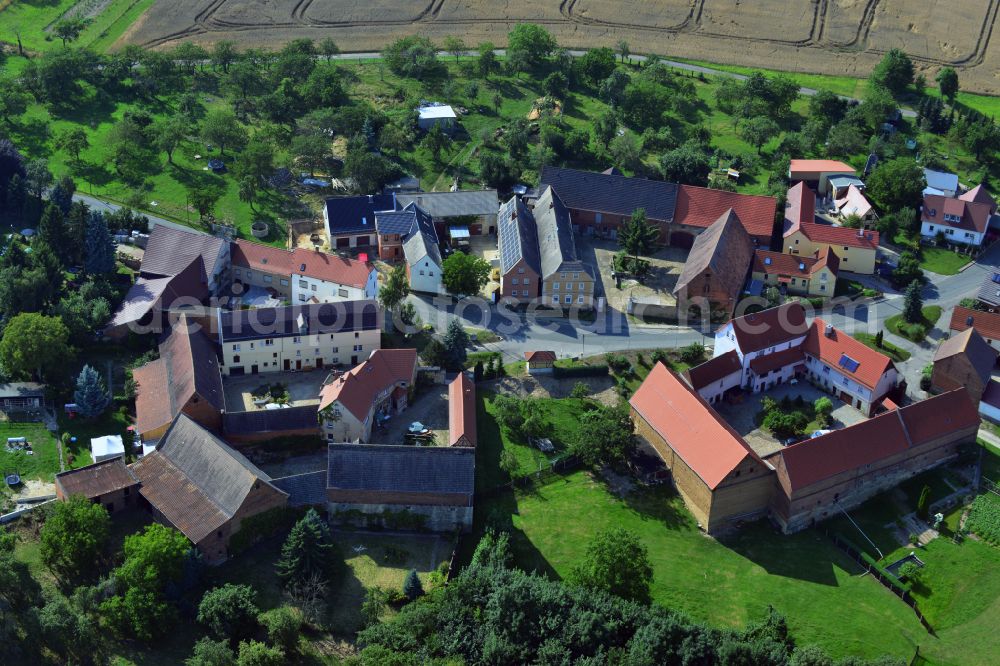 Aerial image Launewitz - Agricultural land and field boundaries surround the settlement area of the village in Launewitz in the state Thuringia, Germany