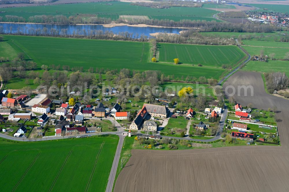 Löbersdorf from the bird's eye view: Agricultural land and field boundaries surround the settlement area of the village in Löbersdorf in the state Saxony-Anhalt, Germany