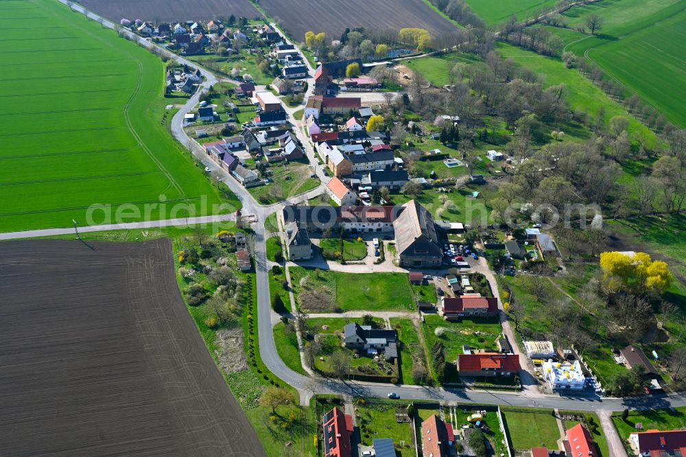 Löbersdorf from the bird's eye view: Agricultural land and field boundaries surround the settlement area of the village in Löbersdorf in the state Saxony-Anhalt, Germany