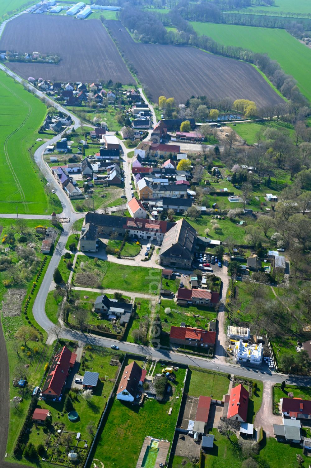 Aerial image Löbersdorf - Agricultural land and field boundaries surround the settlement area of the village in Löbersdorf in the state Saxony-Anhalt, Germany