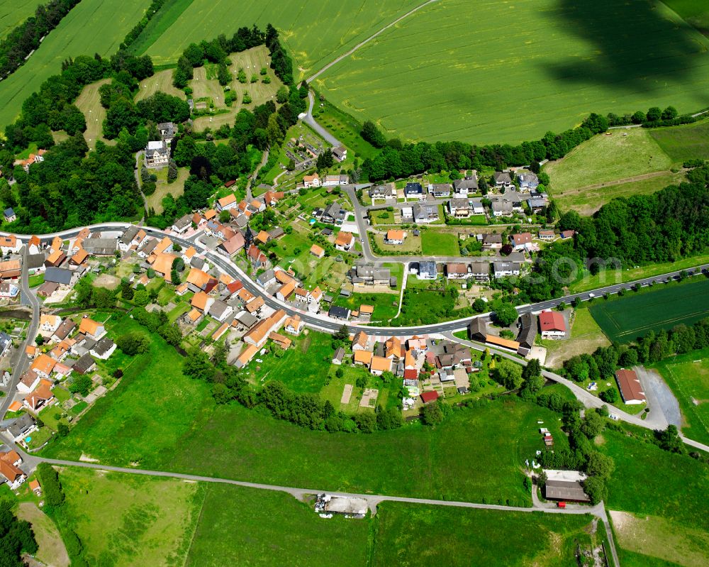 Aerial photograph Lehrbach - Agricultural land and field boundaries surround the settlement area of the village in Lehrbach in the state Hesse, Germany