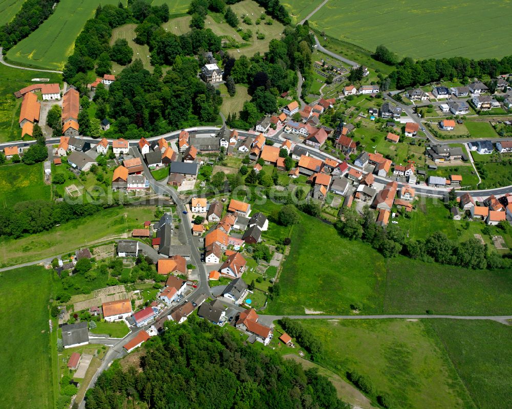 Lehrbach from the bird's eye view: Agricultural land and field boundaries surround the settlement area of the village in Lehrbach in the state Hesse, Germany