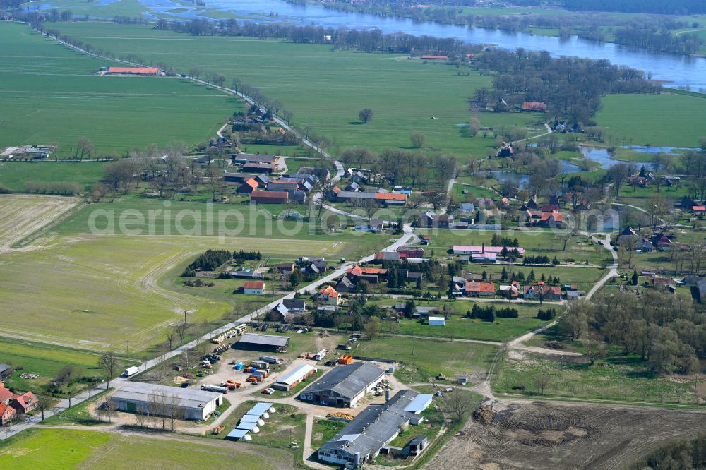 Lenzerwische from above - Agricultural land and field boundaries surround the settlement area of the village in Lenzerwische in the state Brandenburg, Germany