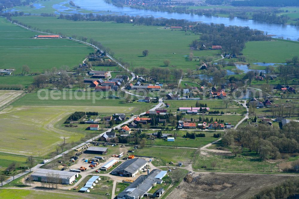 Lenzerwische from the bird's eye view: Agricultural land and field boundaries surround the settlement area of the village in Lenzerwische in the state Brandenburg, Germany