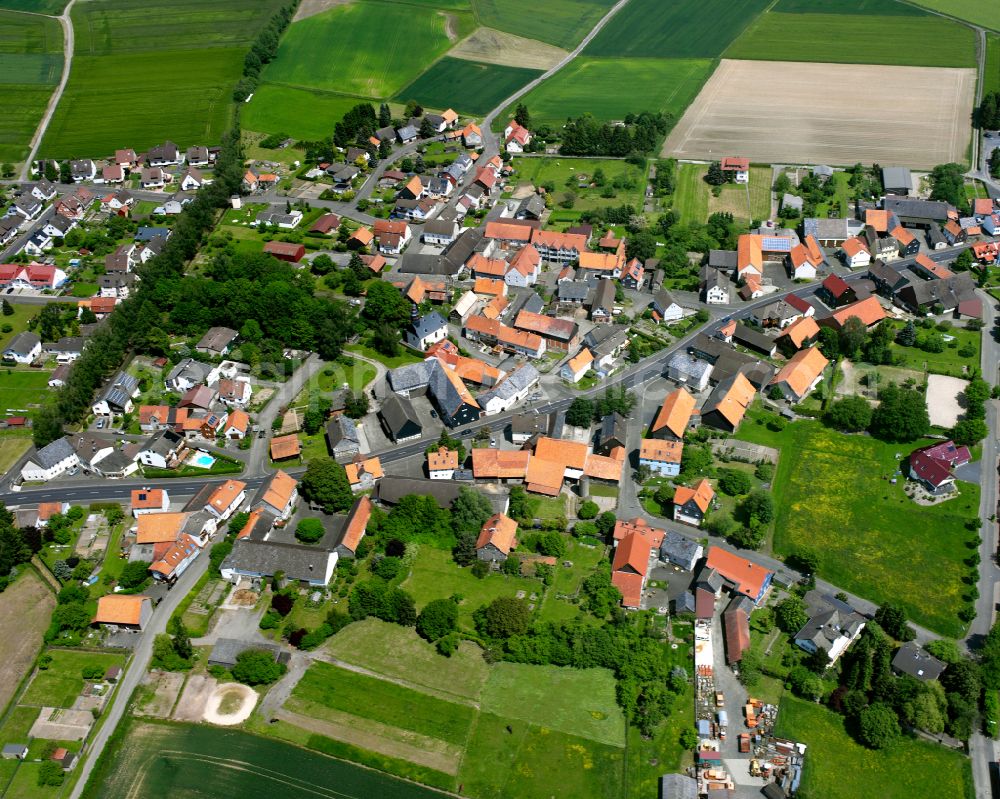 Leusel from the bird's eye view: Agricultural land and field boundaries surround the settlement area of the village in Leusel in the state Hesse, Germany