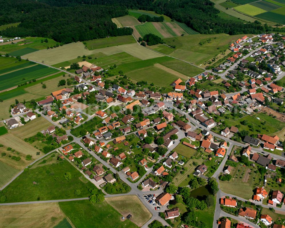 Liebelsberg from above - Agricultural land and field boundaries surround the settlement area of the village in Liebelsberg in the state Baden-Wuerttemberg, Germany