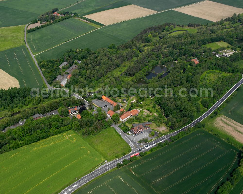 Liebenburg from the bird's eye view: Agricultural land and field boundaries surround the settlement area of the village in Liebenburg in the state Lower Saxony, Germany